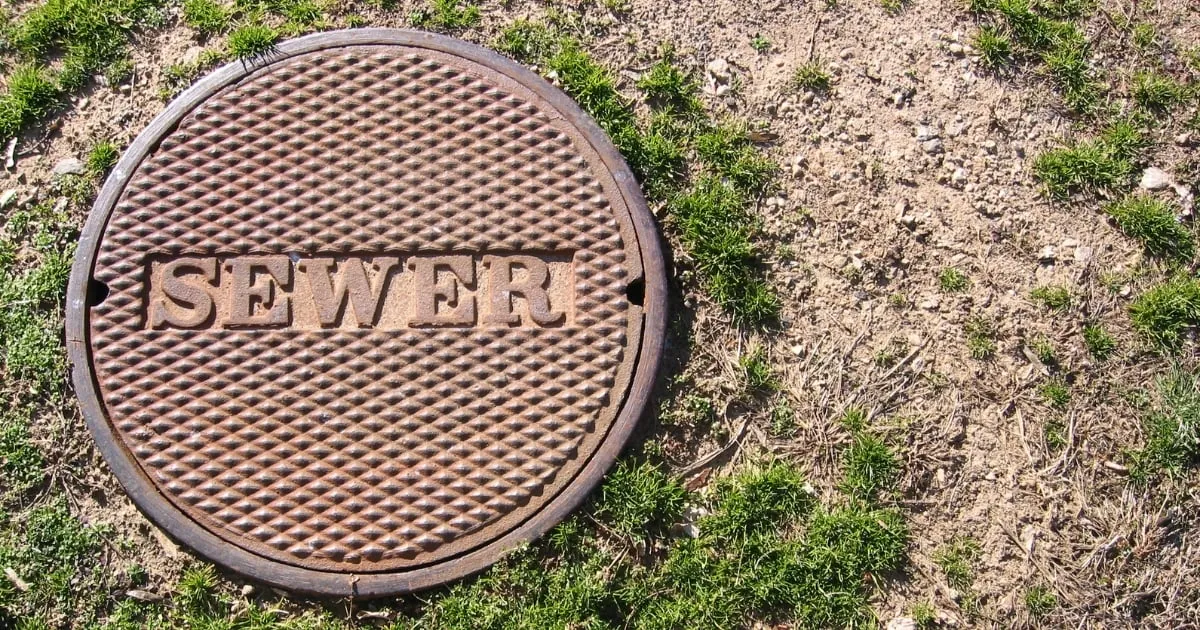 a sewer system with grass around it