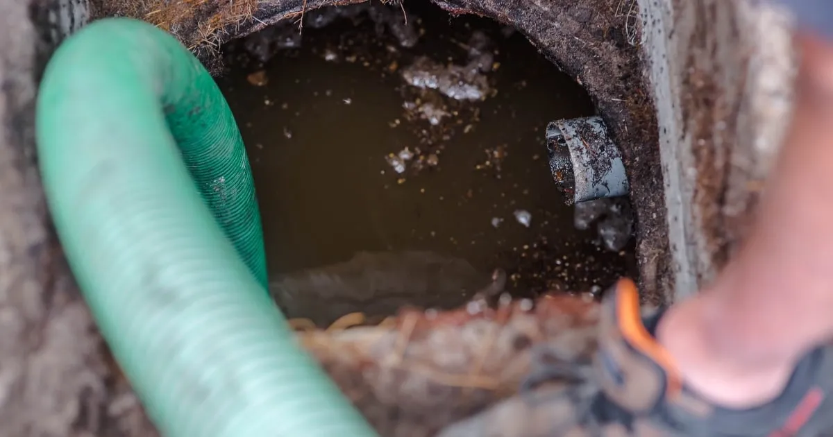 a plumbing tube and a dirty septic tank