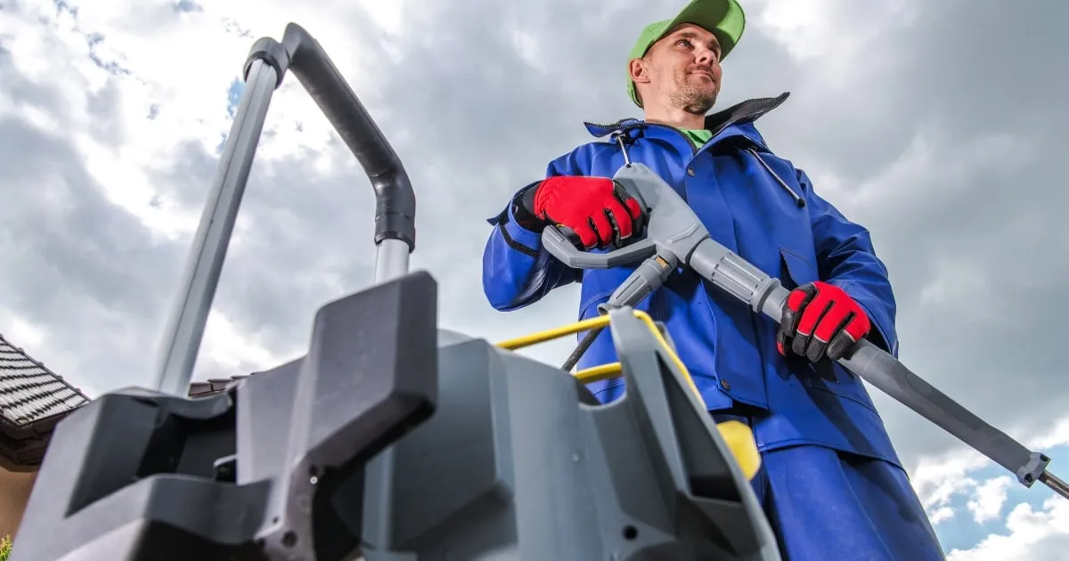 a man holding a high-pressure jet blaster