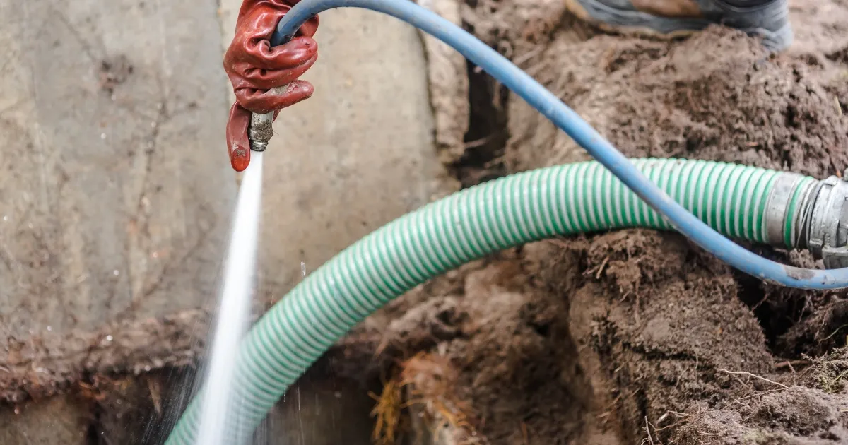 a person cleaning the septic tank with water