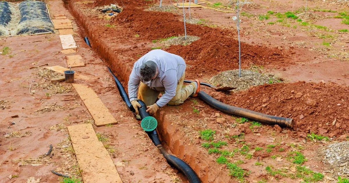 a man holding a plumbing tube