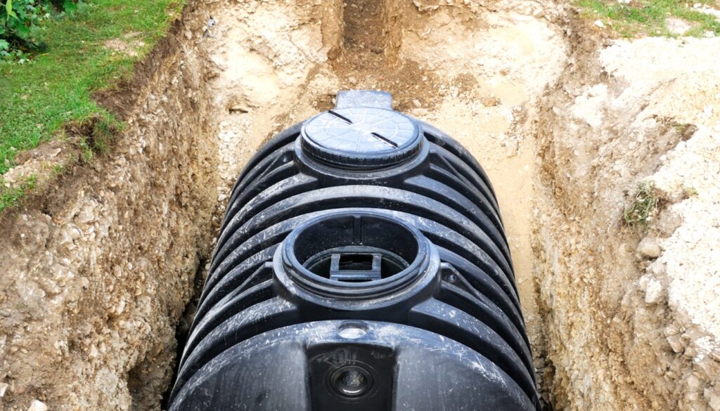 Black septic system buried in soil